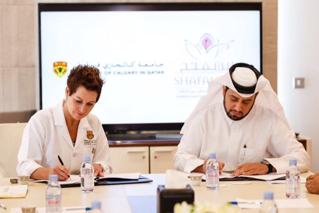 Kim Critchley, UCQ Dean and CEO, and Mohammed Al-Sada, managing director of the Shafallah Center, sign the international partnership agreement.