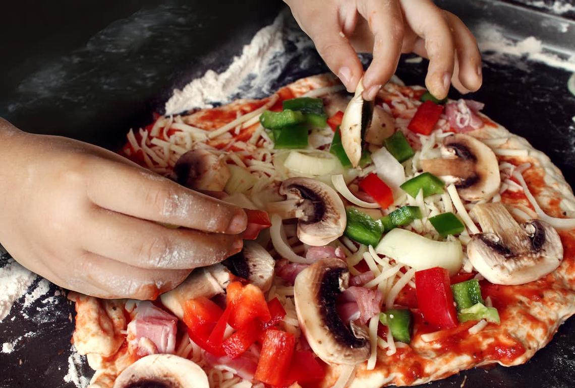 Given the opportunity, children take pride in creating their own pizza and contributing to dinner.