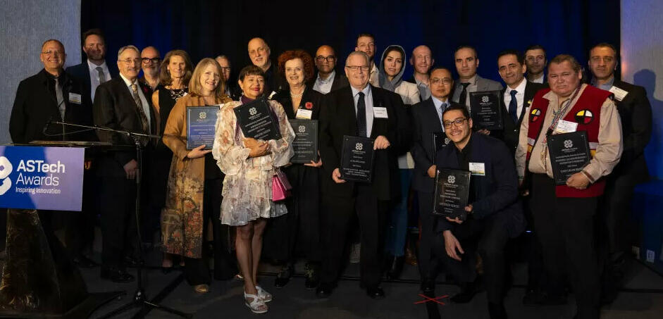 2023 AsTech Award winenrs pose holidn their plaques