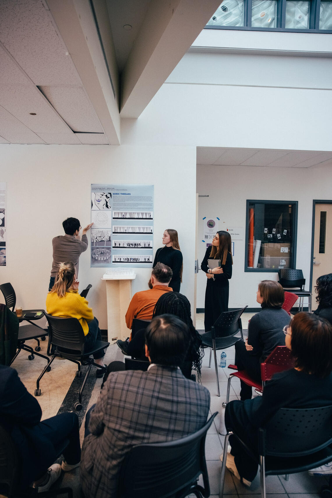 Allysen and her groupmates presenting a project in front of fellow students.