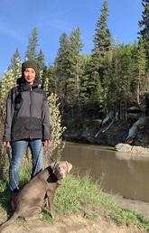 Graduating with an MA in Geography, Kristy Myles enjoys a walk in Fish Creek Park with her dog, Whiskey.