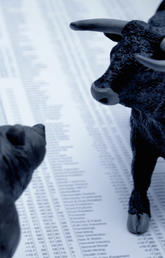 Bear and bull on finance pages of newspaper