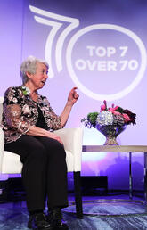 Bonnie Kaplan and Dave Kelly on stage at the Top7 over 70 Awards Gala in May 2022