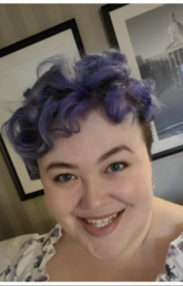 A woman with short purple hair