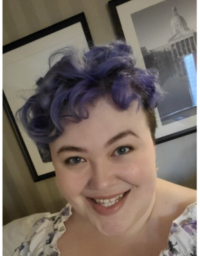 A woman with short purple hair