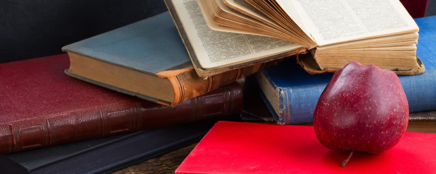 An apple on a stack of books