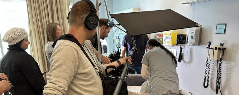 Camera crew filming in clinical setting