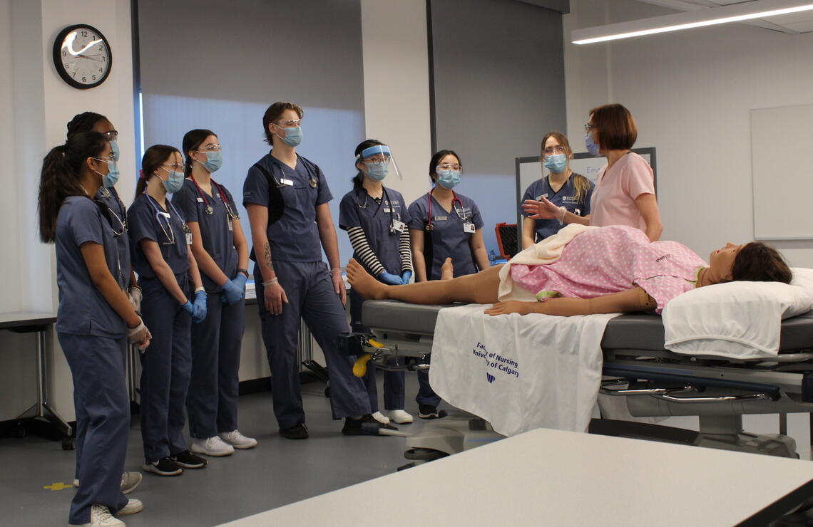 Nursing students and instructor with birthing mannikin