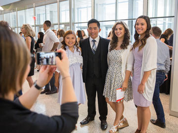 Students pose for last minute group photos before heading to the Jack Simpson gym for the convocation ceremony.