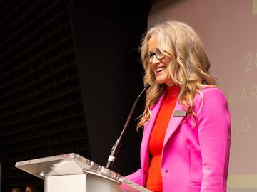 Associate dean undergraduate education speaks to crowd behind podium
