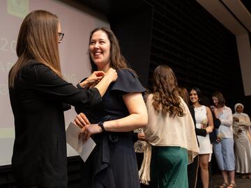 Students cross Pinning Ceremony stage