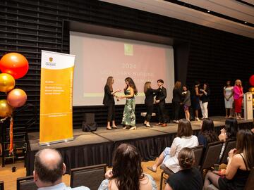 Students cross Pinning Ceremony stage.