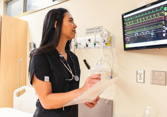 woman looking at screen in hospital room