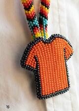 beaded necklace; orange tshirt