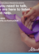 Two sets of hands cupped together, holding a purple ribbon in the hands